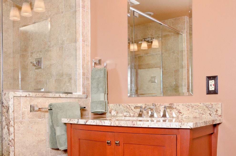 Inspiration for a large transitional master beige tile and stone tile travertine floor double shower remodel in Chicago with recessed-panel cabinets, medium tone wood cabinets, a two-piece toilet, beige walls, an undermount sink and granite countertops