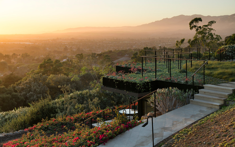 Inspiration for a contemporary backyard full sun garden in Santa Barbara with natural stone pavers.