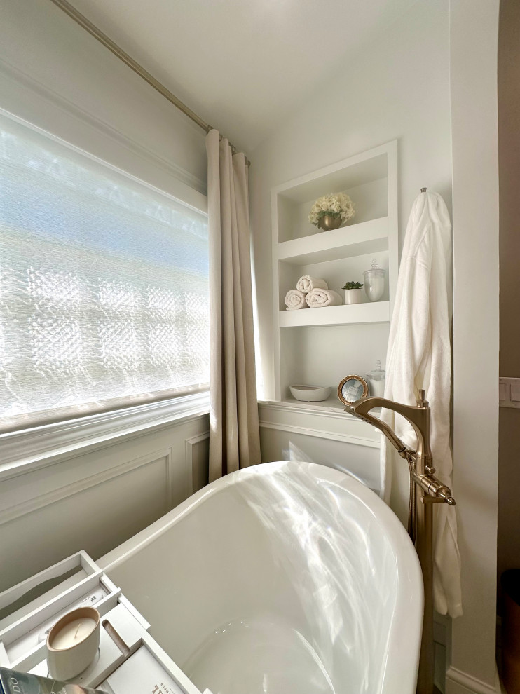 Freestanding bathtub - mid-sized transitional master white tile and marble tile porcelain tile, white floor, double-sink and wainscoting freestanding bathtub idea with recessed-panel cabinets, white cabinets, a two-piece toilet, brown walls, an undermount sink, quartz countertops, a hinged shower door, white countertops and a built-in vanity