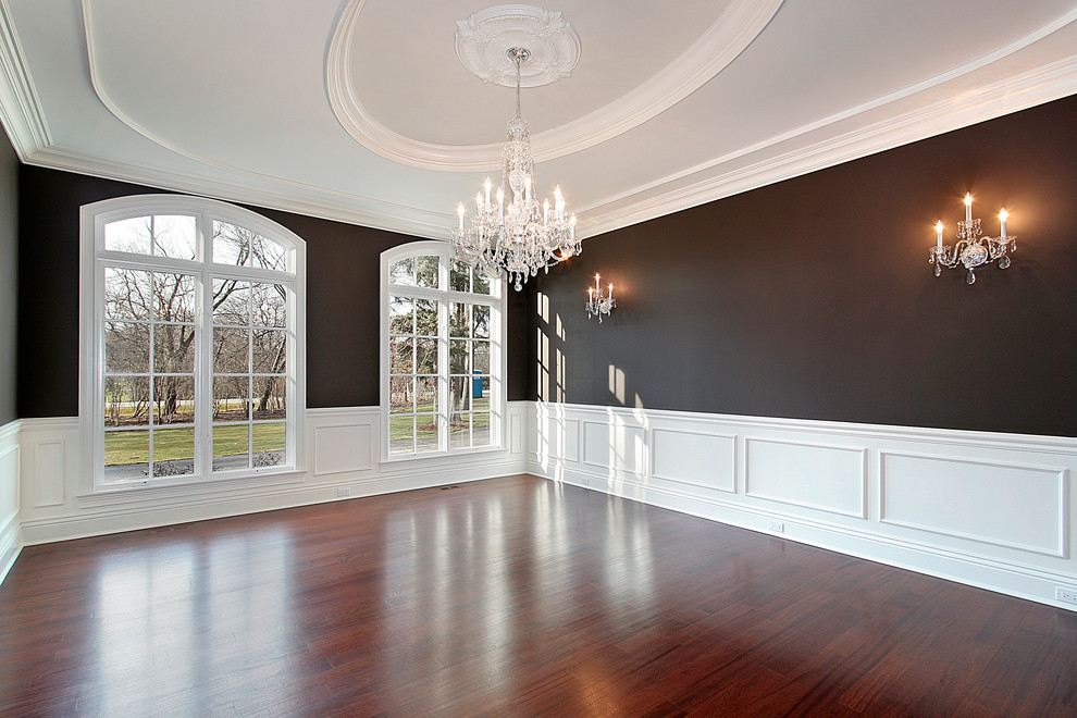 Inspiration for a large traditional separate dining room in Chicago with black walls, dark hardwood floors and no fireplace.