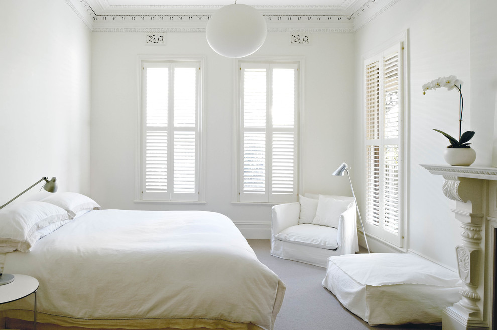 Design ideas for a transitional master bedroom in Melbourne with white walls.