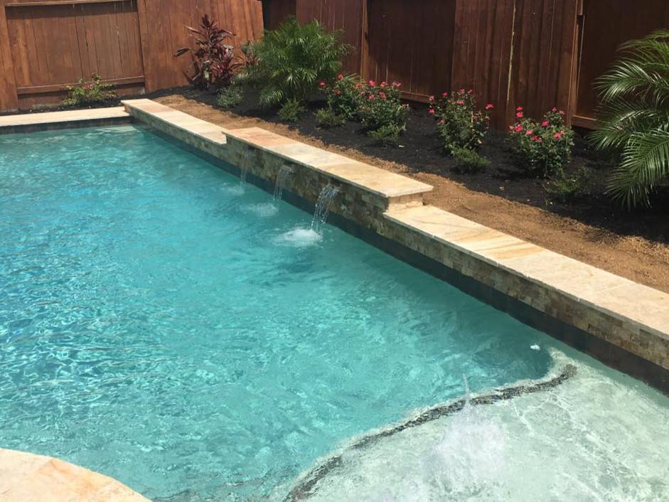 This is an example of a mid-sized transitional backyard rectangular pool in Orange County with a hot tub and concrete pavers.