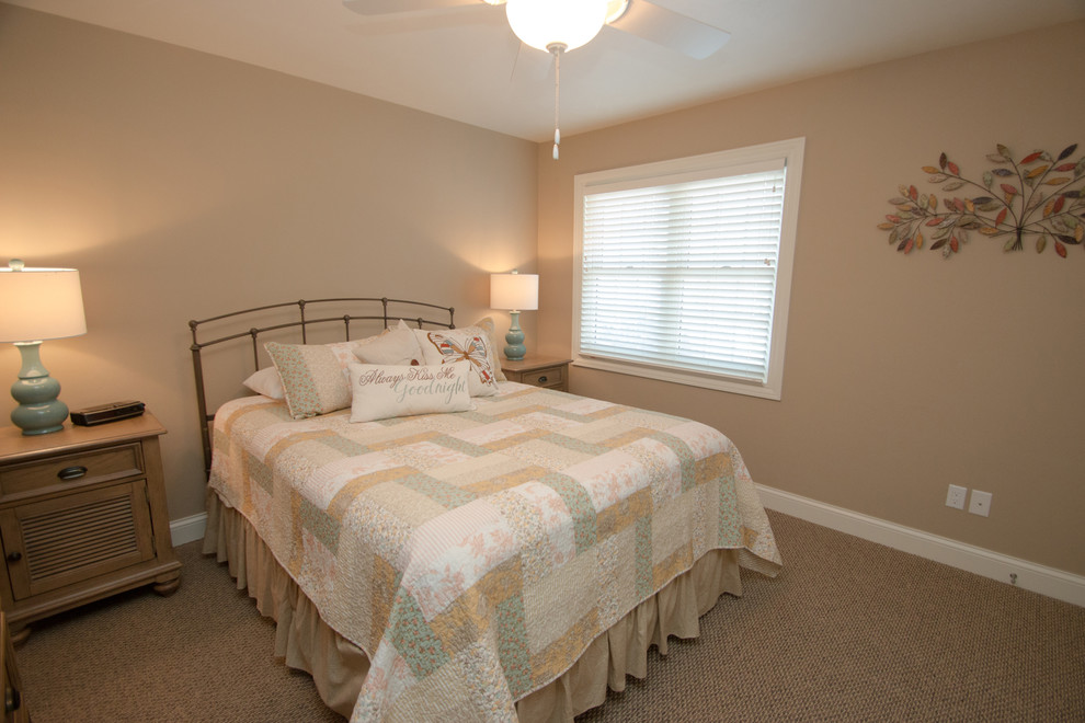 Inspiration for a mid-sized beach style guest bedroom in Milwaukee with beige walls and carpet.