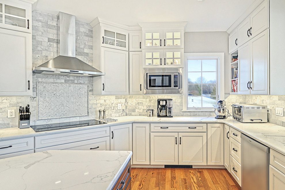Huge transitional u-shaped medium tone wood floor and brown floor eat-in kitchen photo with an undermount sink, beaded inset cabinets, dark wood cabinets, quartz countertops, multicolored backsplash, marble backsplash, stainless steel appliances, an island and white countertops