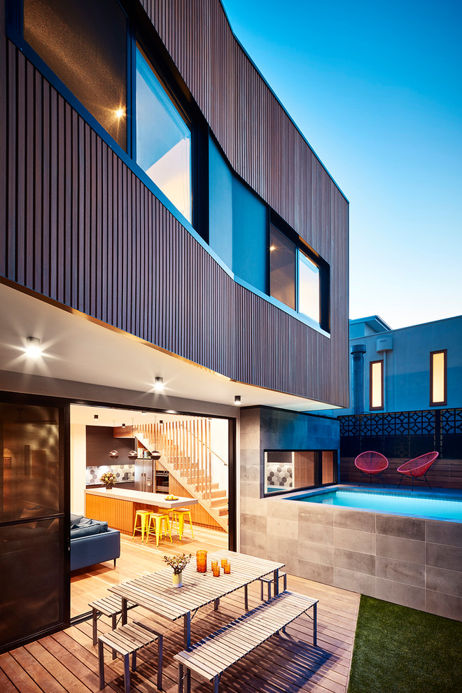 Small contemporary two-storey brown house exterior in Melbourne with wood siding, a flat roof and a metal roof.