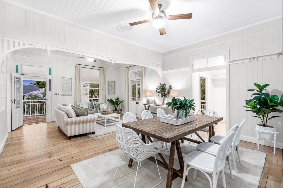 Photo of a beach style dining room in Brisbane with timber and planked wall panelling.