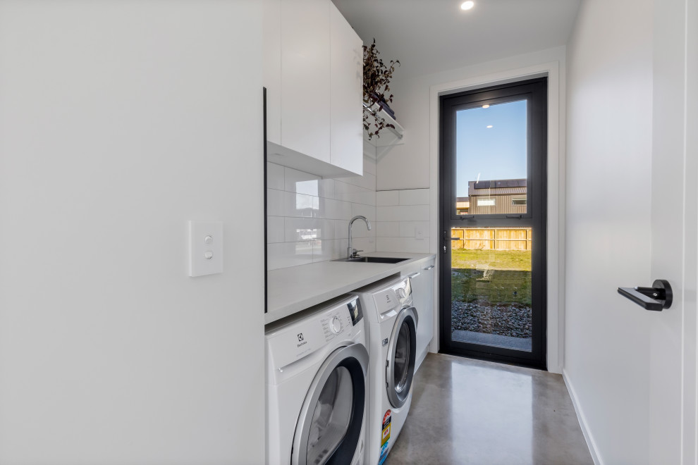 Design ideas for a mid-sized modern galley dedicated laundry room in Other.