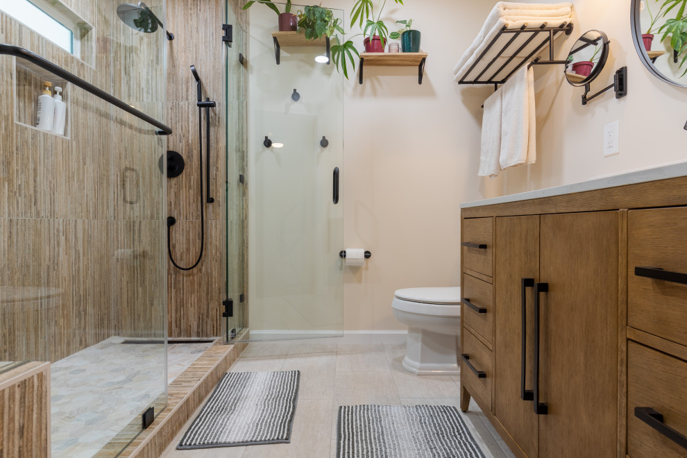 На фото: ванная комната среднего размера в стиле модернизм с коричневыми фасадами, душем в нише, унитазом-моноблоком, разноцветной плиткой, керамической плиткой, белыми стенами, полом из керамической плитки, душевой кабиной, врезной раковиной, столешницей из искусственного кварца, душем с распашными дверями, белой столешницей, сиденьем для душа, тумбой под одну раковину, кирпичными стенами, плоскими фасадами, напольной тумбой и бежевым полом с