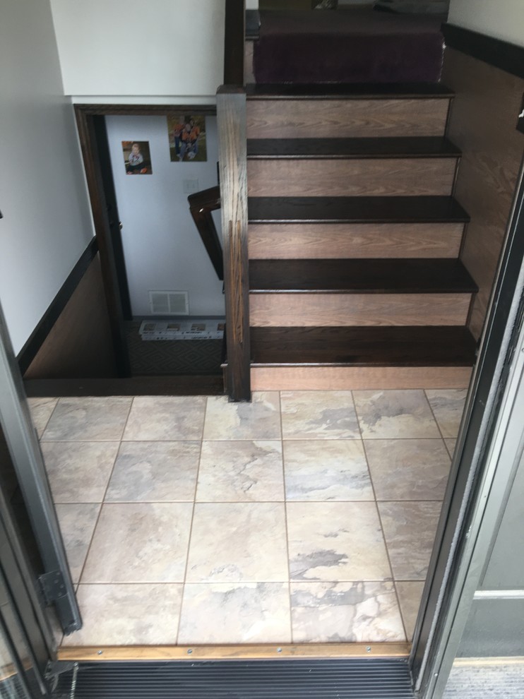 Large mountain style ceramic tile and multicolored floor front door photo in Seattle with beige walls and a black front door