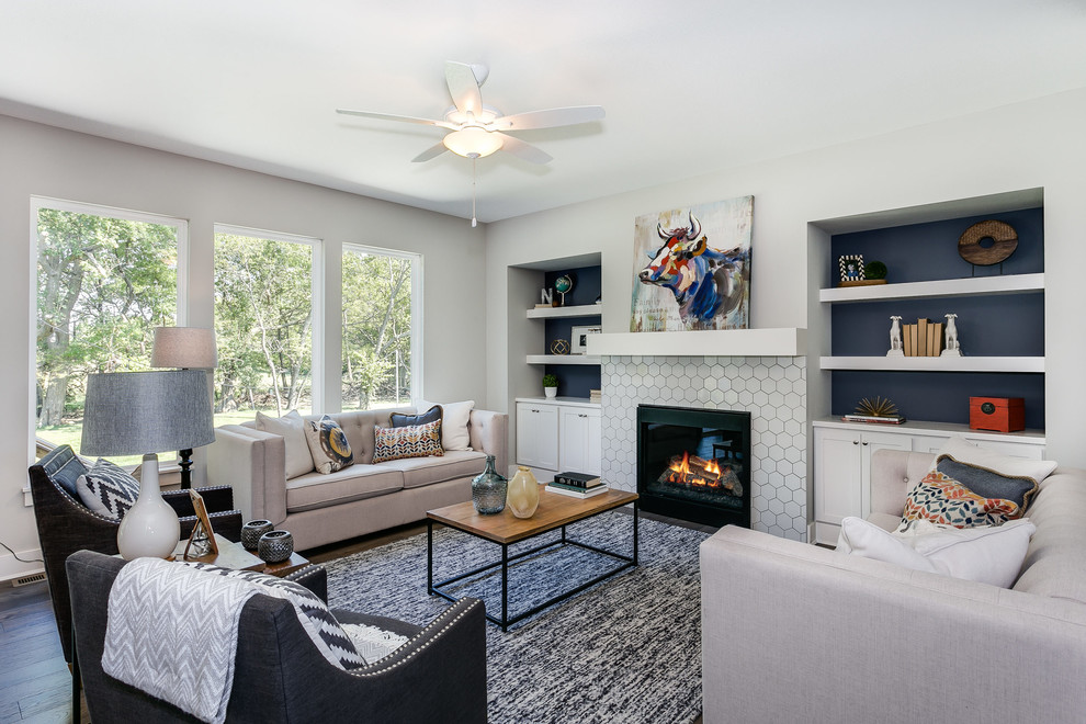 Photo of a mid-sized arts and crafts open concept living room in Wichita with white walls, dark hardwood floors, a standard fireplace, a tile fireplace surround and no tv.
