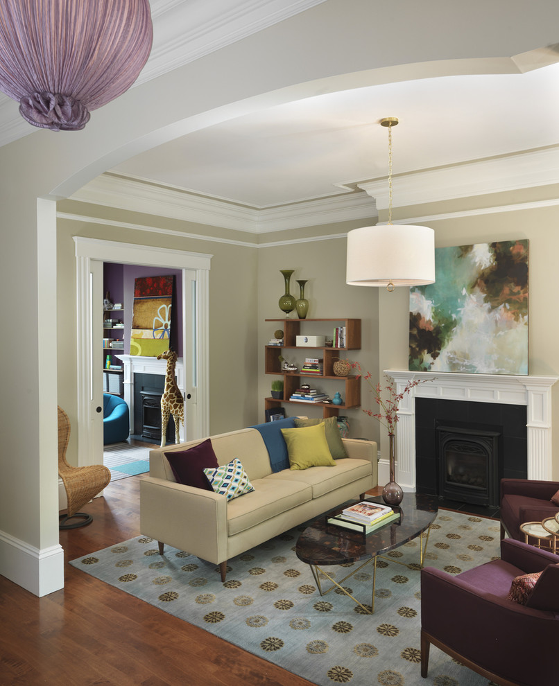 This is an example of a transitional living room in Boston with beige walls, a standard fireplace, medium hardwood floors and no tv.