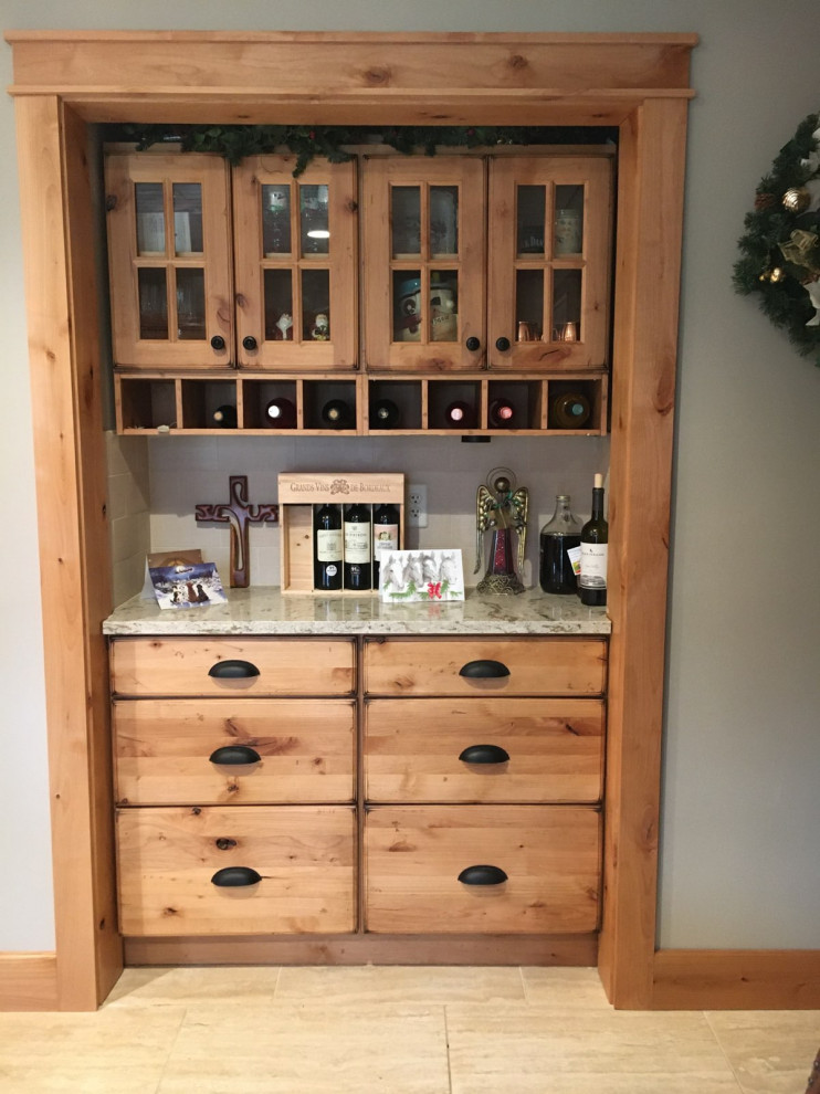 Mountain style kitchen photo with a farmhouse sink, raised-panel cabinets, light wood cabinets and quartz countertops
