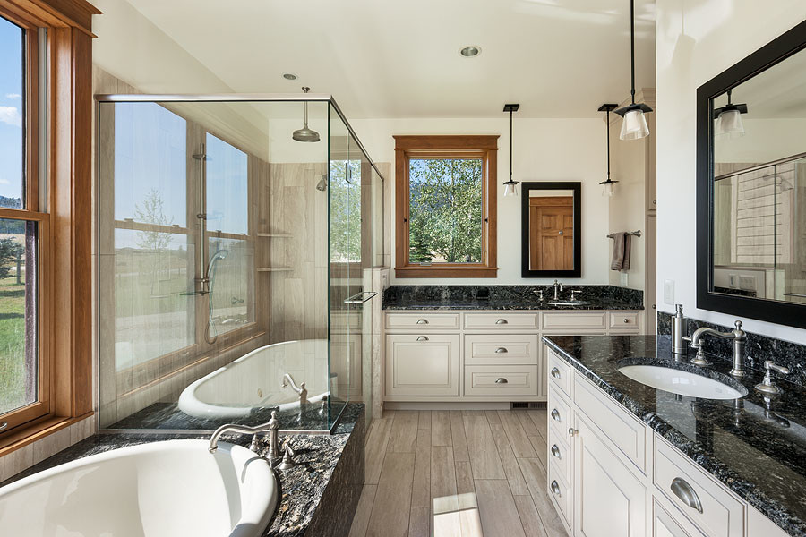 Inspiration for a large transitional master travertine tile travertine floor and beige floor drop-in bathtub remodel with beaded inset cabinets, dark wood cabinets, a two-piece toilet, white walls, an undermount sink, granite countertops, a hinged shower door and multicolored countertops
