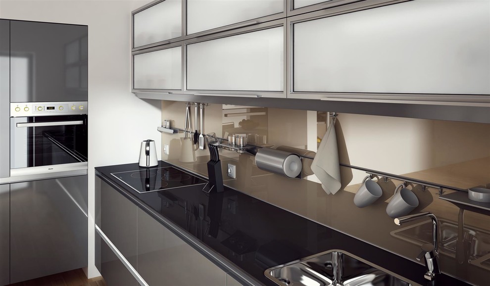 Small minimalist single-wall medium tone wood floor and beige floor eat-in kitchen photo with an undermount sink, flat-panel cabinets, gray cabinets, quartz countertops, beige backsplash, glass sheet backsplash, stainless steel appliances and no island