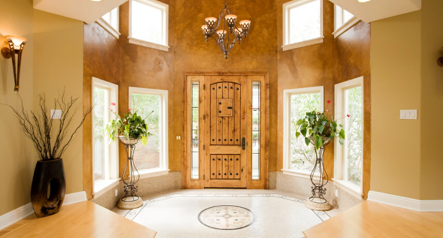 Foyer - large transitional beige floor foyer idea in Houston with brown walls and a medium wood front door