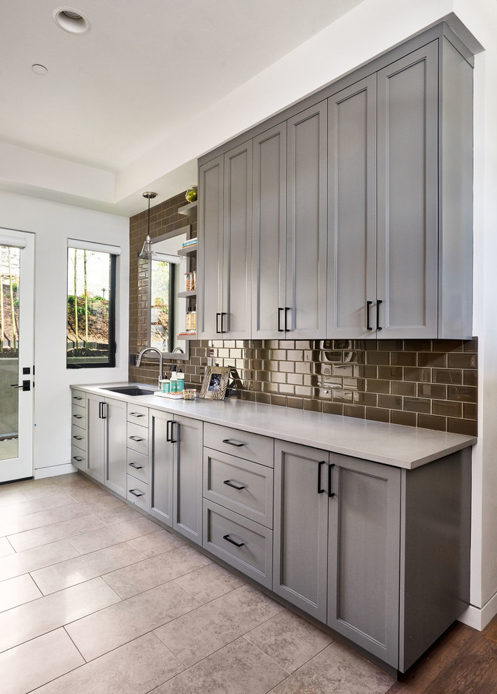 Inspiration for a large contemporary galley utility room in Portland with an undermount sink, shaker cabinets, grey cabinets, concrete benchtops, white walls and porcelain floors.