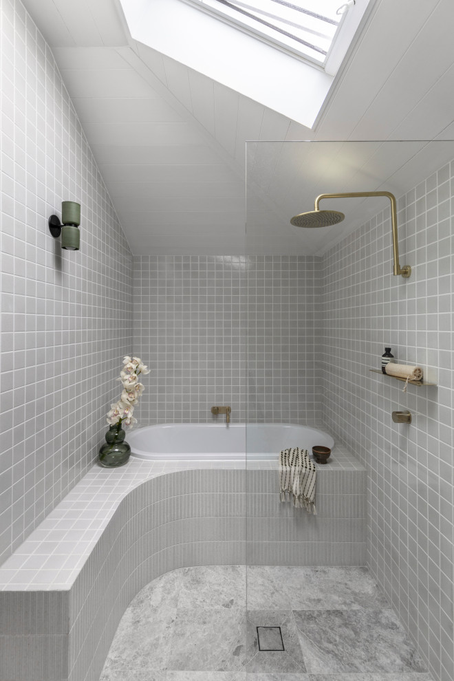 Inspiration for a small contemporary master bathroom in Sydney with a drop-in tub, an open shower, a two-piece toilet, white tile, ceramic tile, white walls, limestone floors, a wall-mount sink, concrete benchtops, grey floor, an open shower, grey benchtops, a single vanity and a floating vanity.
