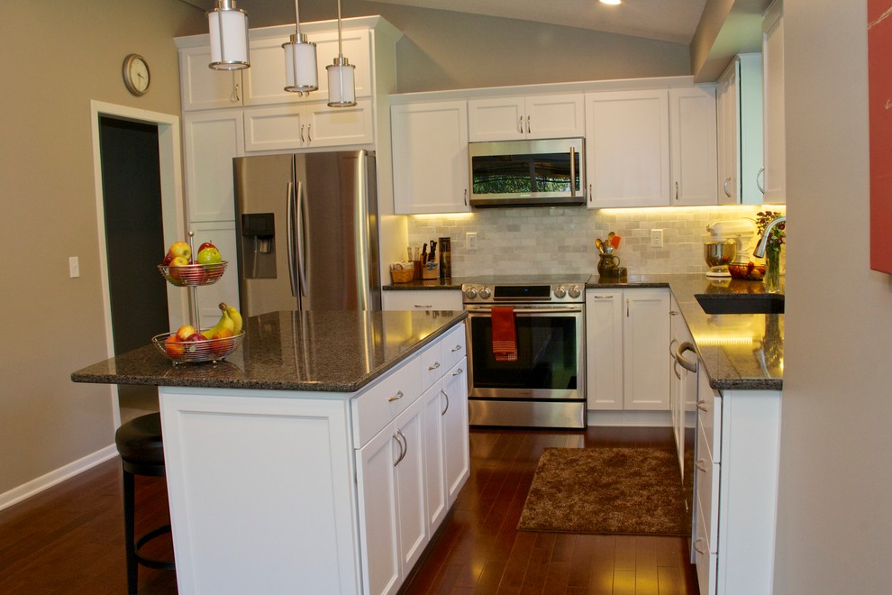 Eat-in kitchen - mid-sized transitional l-shaped dark wood floor eat-in kitchen idea in Minneapolis with an undermount sink, shaker cabinets, white cabinets, quartzite countertops, gray backsplash, subway tile backsplash, stainless steel appliances, beige walls and an island