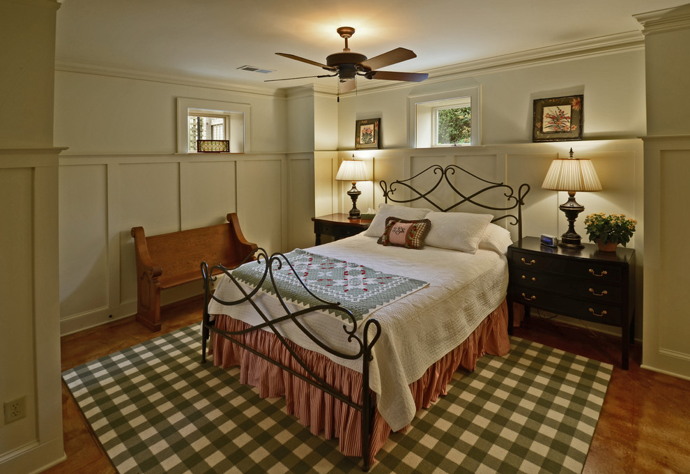 This is an example of a country guest bedroom in Other with white walls and concrete floors.
