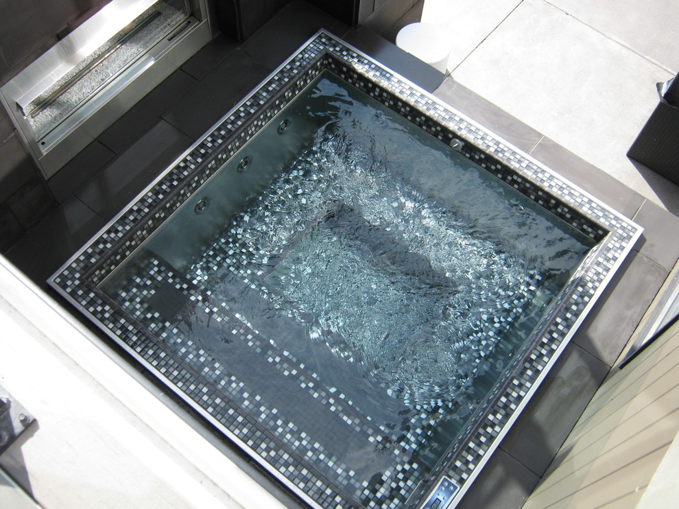 This is an example of a contemporary rectangular pool in Other with a hot tub.