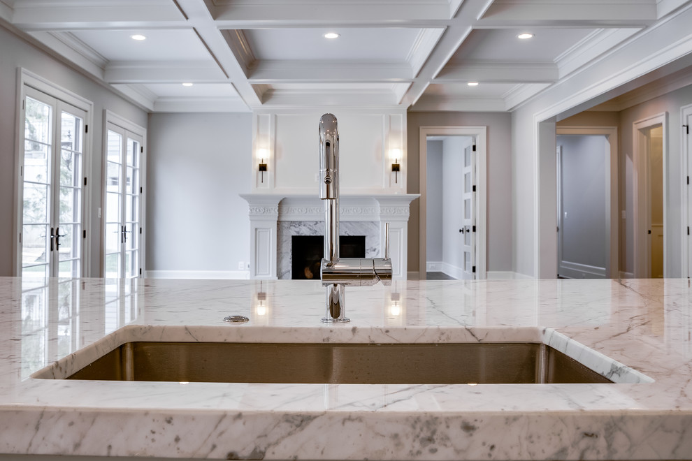 This is an example of a large transitional u-shaped open plan kitchen in DC Metro with an undermount sink, recessed-panel cabinets, white cabinets, marble benchtops, multi-coloured splashback, marble splashback, panelled appliances, dark hardwood floors, with island, brown floor and multi-coloured benchtop.