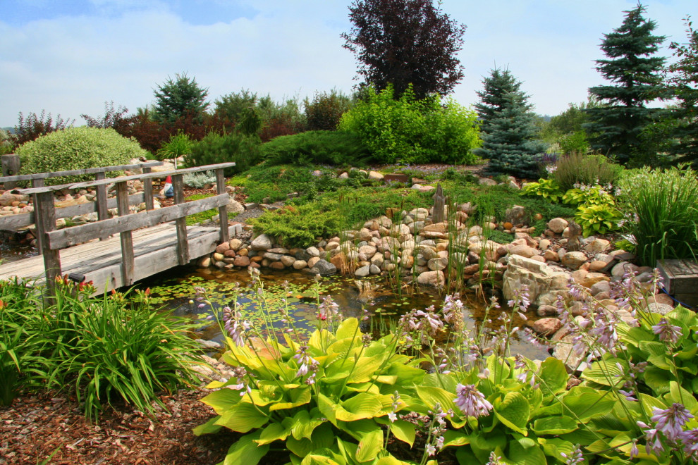 Inspiration for a huge traditional backyard pond in Edmonton.
