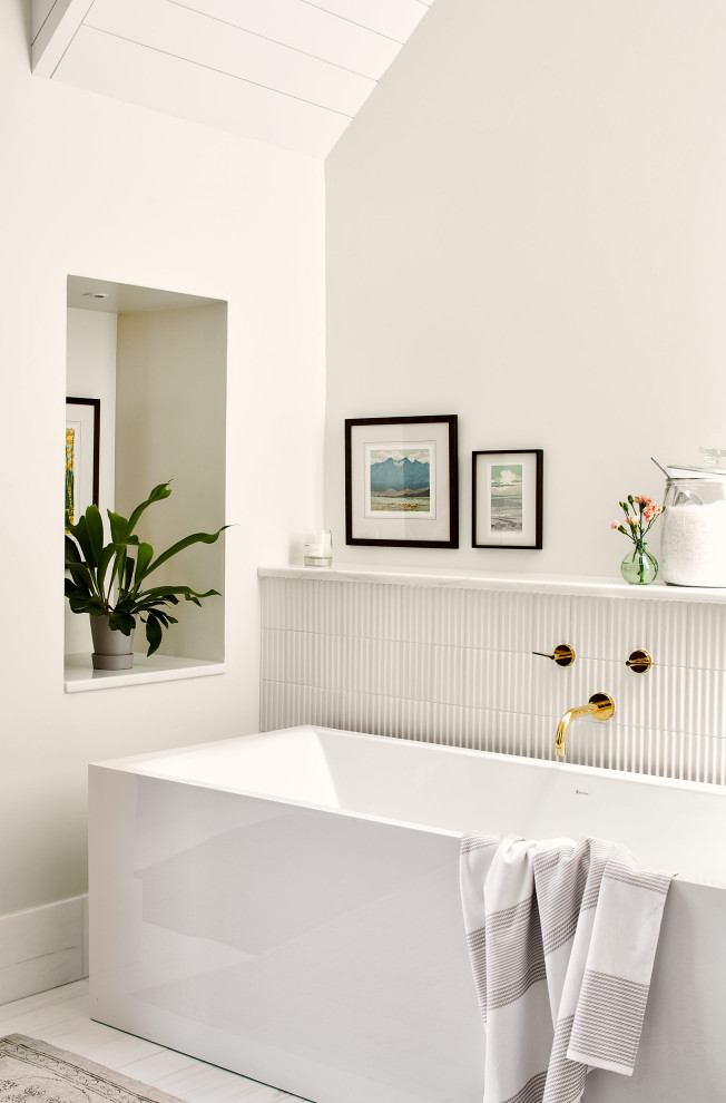 This is an example of a medium sized rural ensuite bathroom in Denver with a freestanding bath, white tiles, white walls and a vaulted ceiling.
