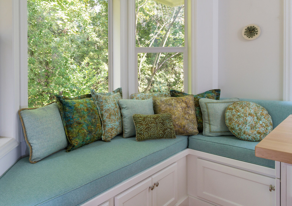 Example of a transitional galley enclosed kitchen design in Raleigh with raised-panel cabinets, white cabinets, wood countertops, gray backsplash, ceramic backsplash and white appliances