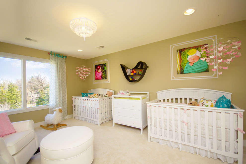 This is an example of a mid-sized traditional nursery for girls in Detroit with green walls and carpet.