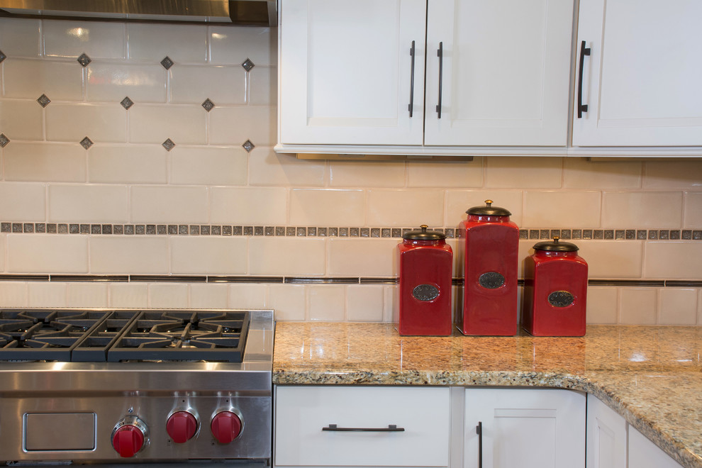Inspiration for a huge timeless l-shaped medium tone wood floor open concept kitchen remodel in Columbus with an undermount sink, white cabinets, wood countertops, white backsplash, cement tile backsplash, stainless steel appliances, an island and recessed-panel cabinets
