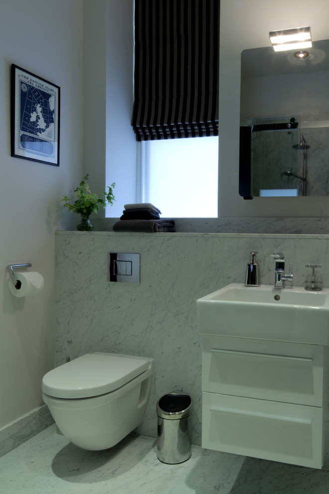 Photo of a small contemporary master bathroom in London with an open shower, a wall-mount toilet, gray tile, grey walls, marble floors, a wall-mount sink and marble benchtops.
