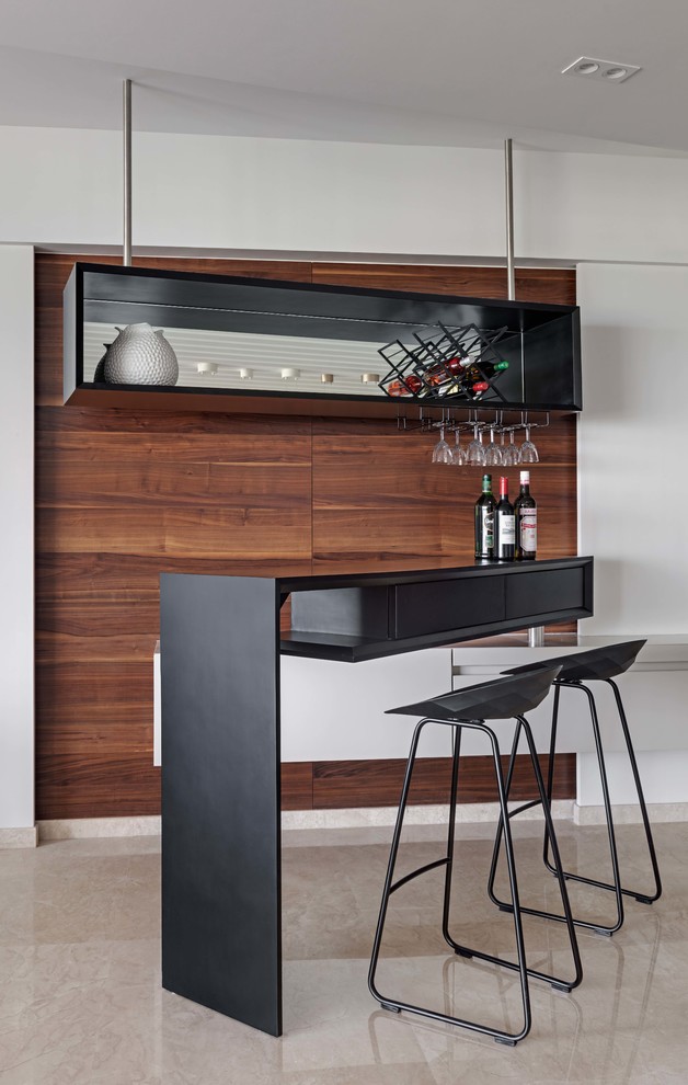 Contemporary seated home bar in Mumbai with open cabinets, black cabinets, beige floor and black benchtop.