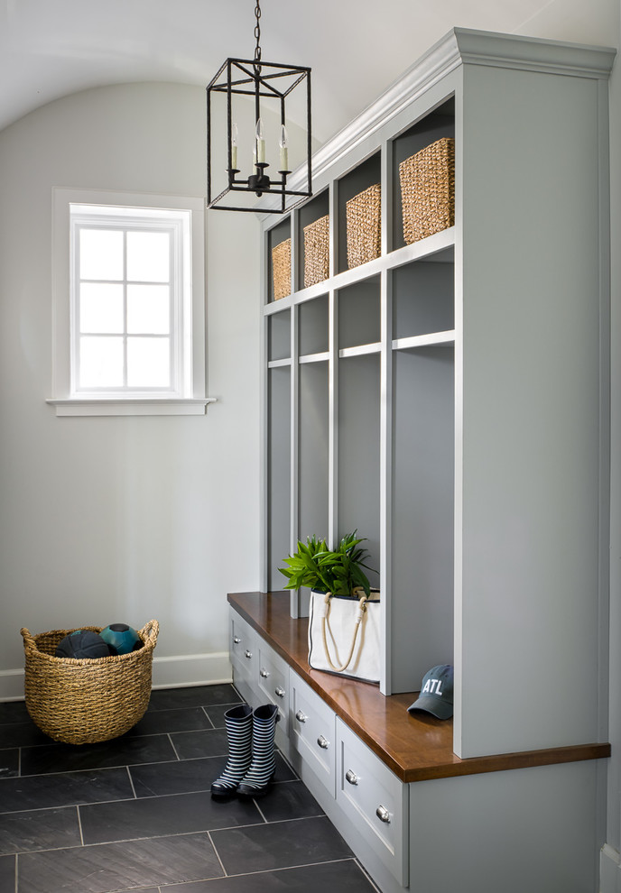 Mid-sized transitional slate floor and black floor mudroom photo in Atlanta with shaker cabinets, wood countertops and gray walls