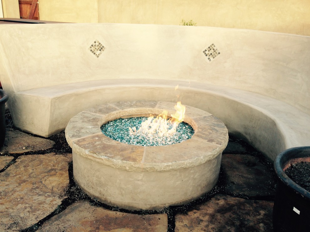 Mid-sized contemporary backyard patio in Santa Barbara with a fire feature, natural stone pavers and no cover.