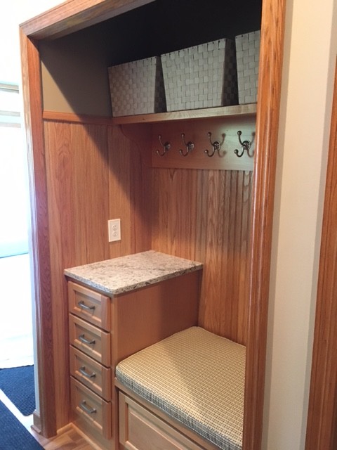 Inspiration for a transitional laminate floor and brown floor home design remodel in Minneapolis with recessed-panel cabinets and light wood cabinets