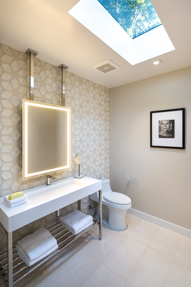 Photo of a mid-sized contemporary powder room in San Francisco with open cabinets, a one-piece toilet, beige tile, ceramic tile, beige walls, porcelain floors, a trough sink and grey floor.