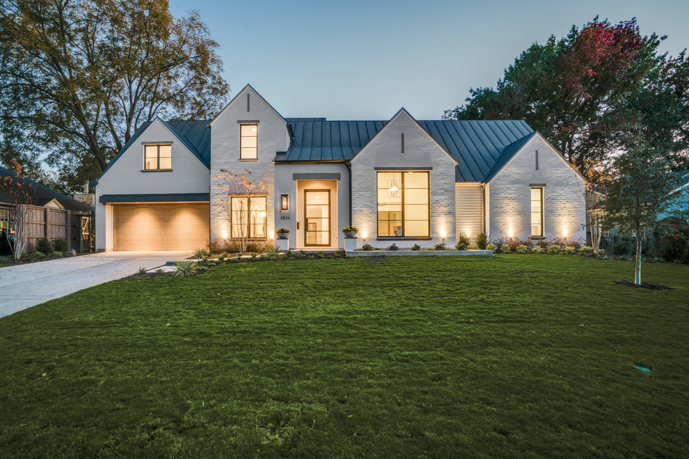 Photo of a mid-sized transitional two-storey brick white exterior in Dallas with a gable roof.