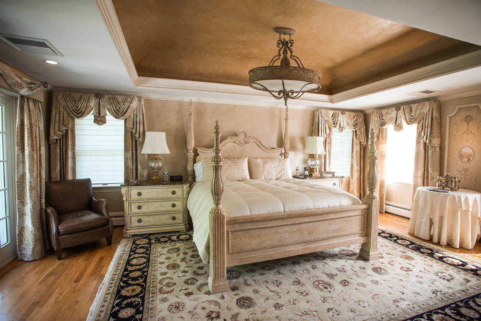 Inspiration for an expansive traditional guest bedroom in Providence with beige walls, medium hardwood floors and no fireplace.