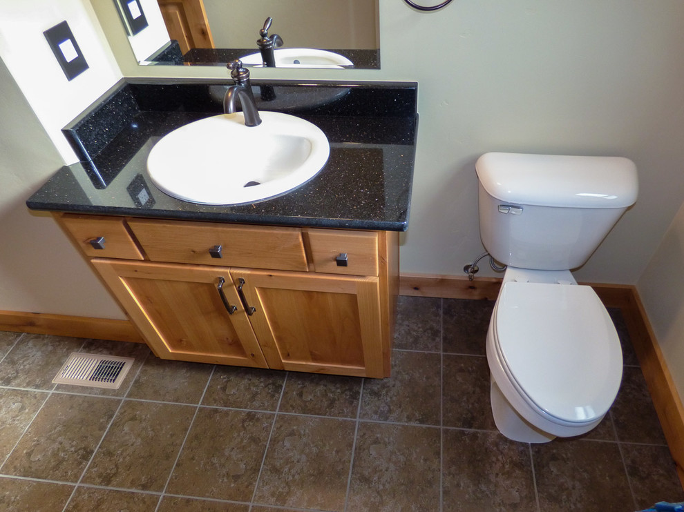 Photo of an arts and crafts bathroom in Other with a drop-in sink, shaker cabinets, light wood cabinets, granite benchtops, a one-piece toilet and slate floors.