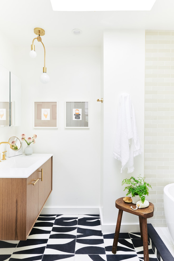 Design ideas for a transitional bathroom in San Francisco with flat-panel cabinets, medium wood cabinets, beige tile, white walls, an integrated sink, multi-coloured floor and white benchtops.