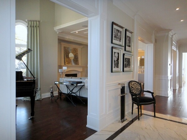 Hallway - large traditional marble floor hallway idea in Houston with beige walls