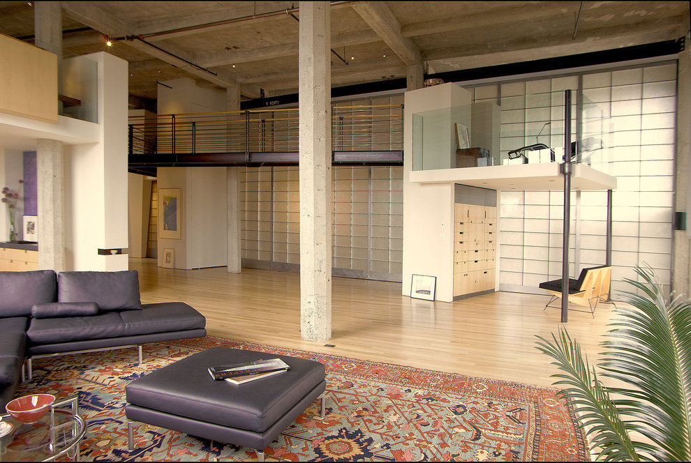 This is an example of an industrial open concept living room in San Francisco.