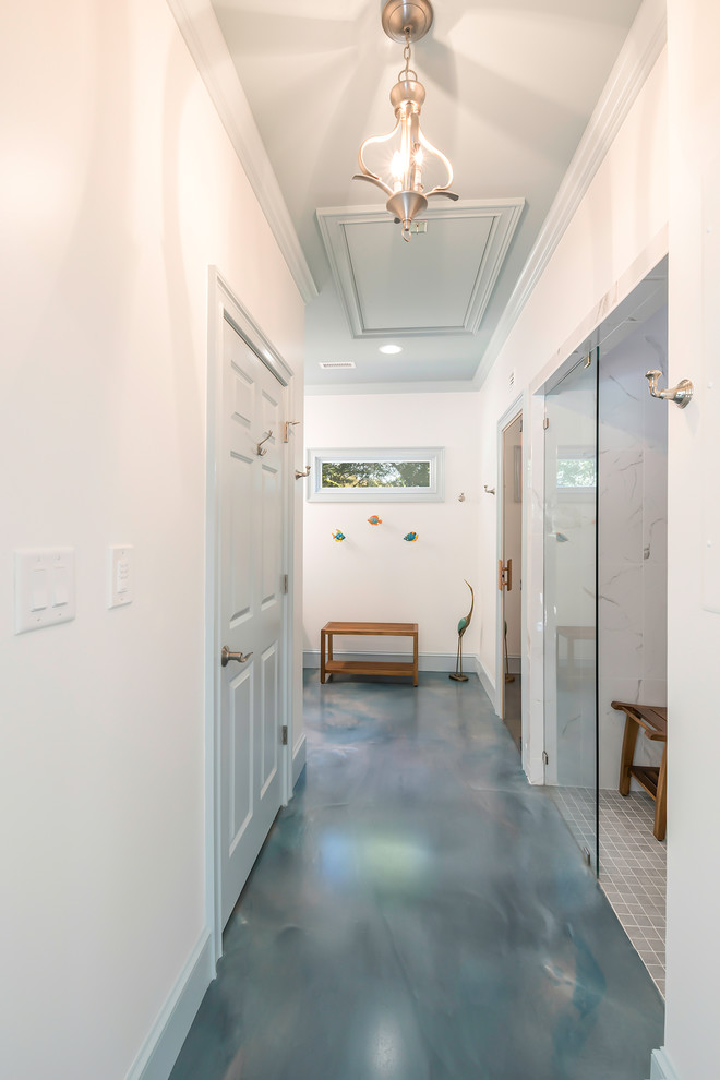 Small beach style hallway in Atlanta with white walls, concrete floors and blue floor.