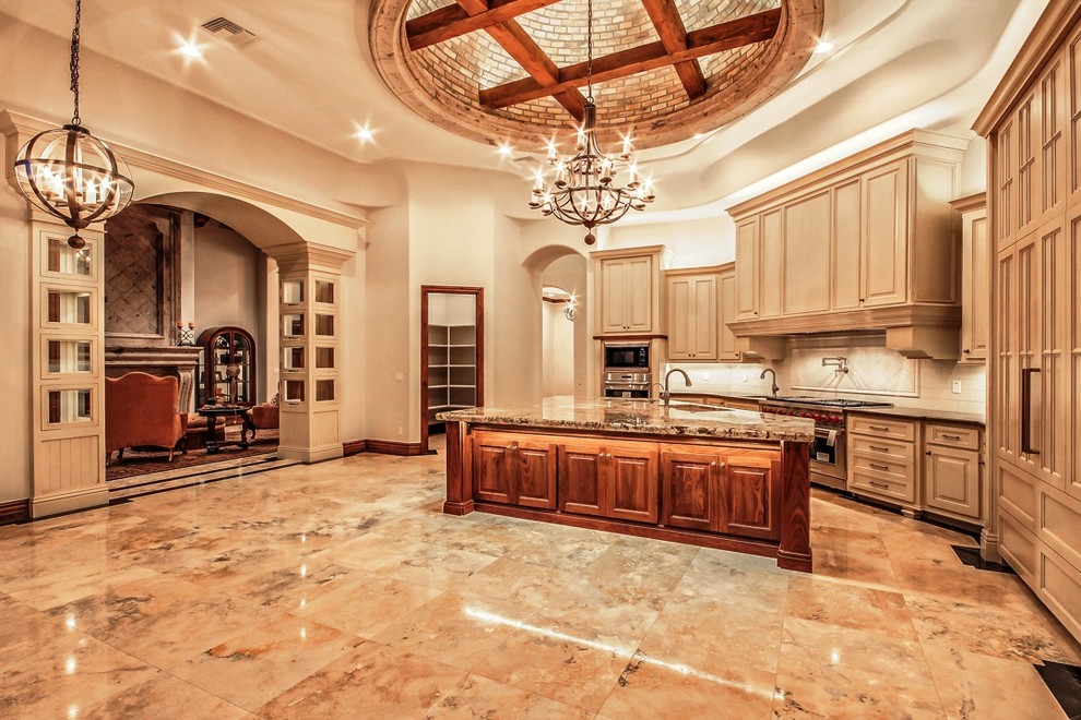 Large arts and crafts l-shaped separate kitchen in Phoenix with an undermount sink, white splashback, ceramic splashback, stainless steel appliances, with island, raised-panel cabinets, beige cabinets, granite benchtops and marble floors.
