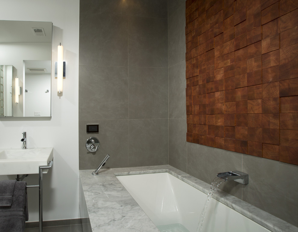 Design ideas for a mid-sized contemporary master bathroom in DC Metro with a console sink, marble benchtops, an undermount tub, a curbless shower, gray tile, porcelain tile, grey walls and porcelain floors.