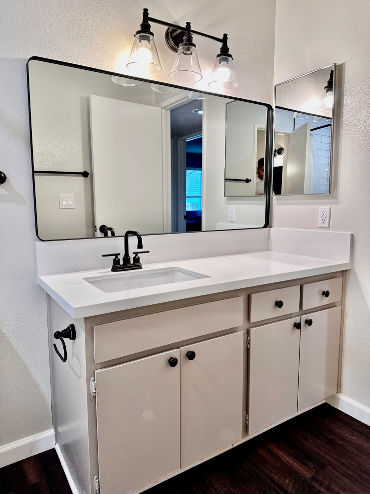 Mid-sized transitional bathroom in Los Angeles with flat-panel cabinets, beige cabinets, a freestanding tub, a shower/bathtub combo, a one-piece toilet, white tile, ceramic tile, grey walls, vinyl floors, an undermount sink, engineered quartz benchtops, brown floor, a shower curtain, white benchtops, a niche, a single vanity and a freestanding vanity.