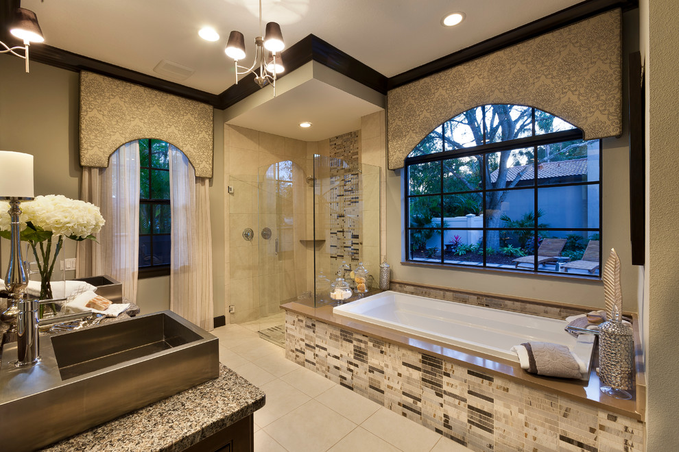 Large contemporary master bathroom in Tampa with flat-panel cabinets, dark wood cabinets, a drop-in tub, a corner shower, a two-piece toilet, beige tile, porcelain tile, beige walls, porcelain floors, a trough sink and granite benchtops.