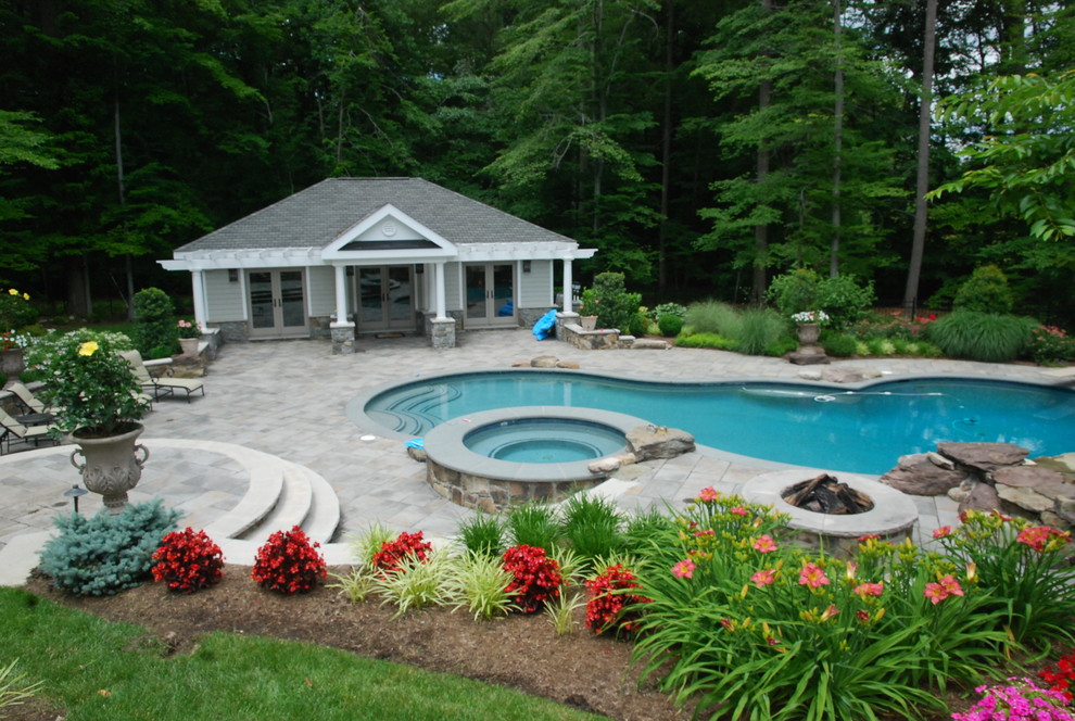 Mid-sized eclectic backyard custom-shaped natural pool in DC Metro with a pool house and concrete pavers.