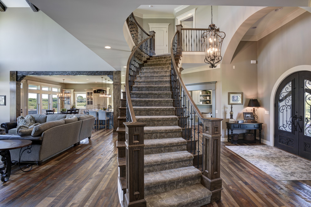 Design ideas for a traditional wood curved staircase in Other with wood risers and mixed railing.