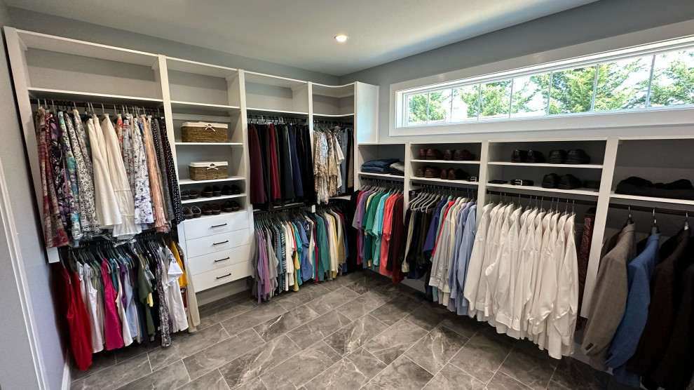 Example of a large transitional gender-neutral laminate floor and gray floor walk-in closet design in Philadelphia with open cabinets and white cabinets